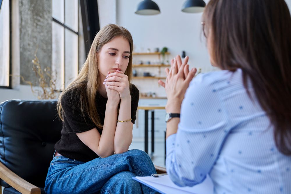 upset woman speaking with therapist