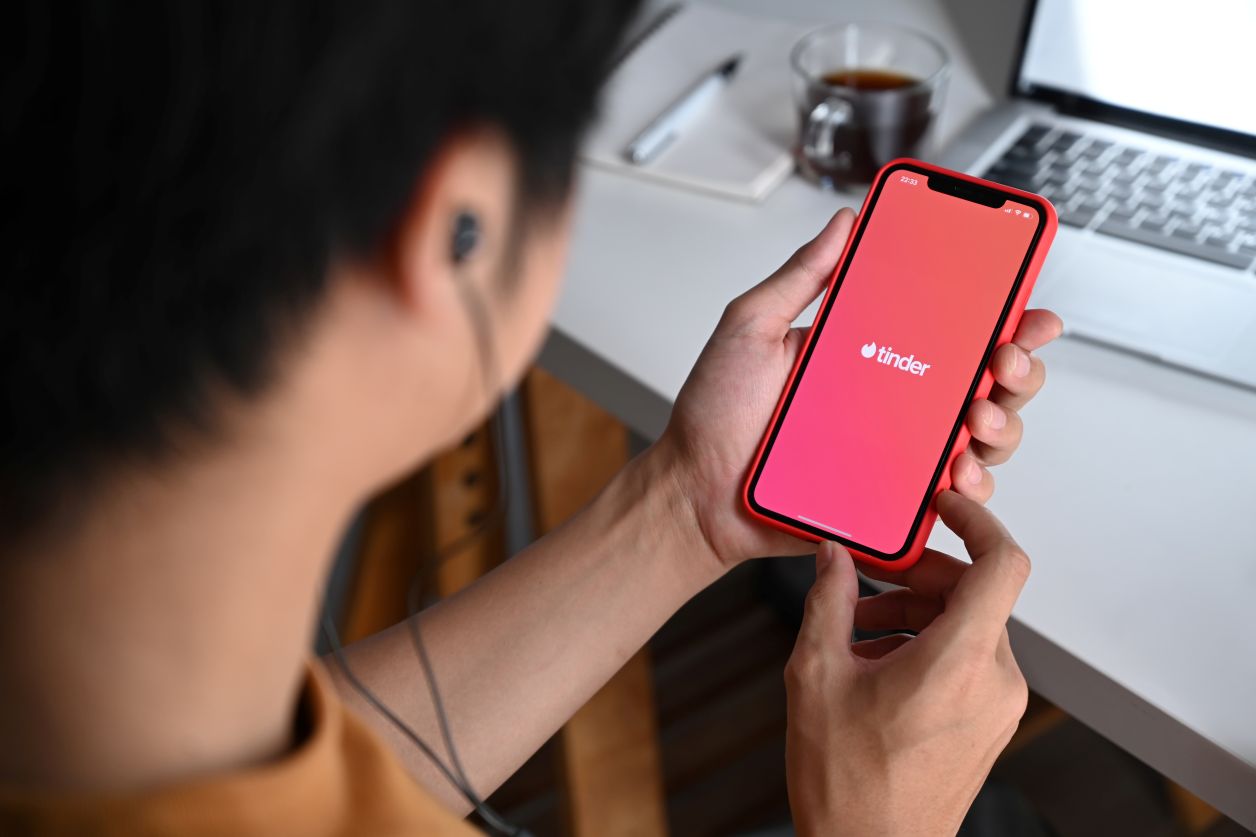 Man opening the Tinder phone application
