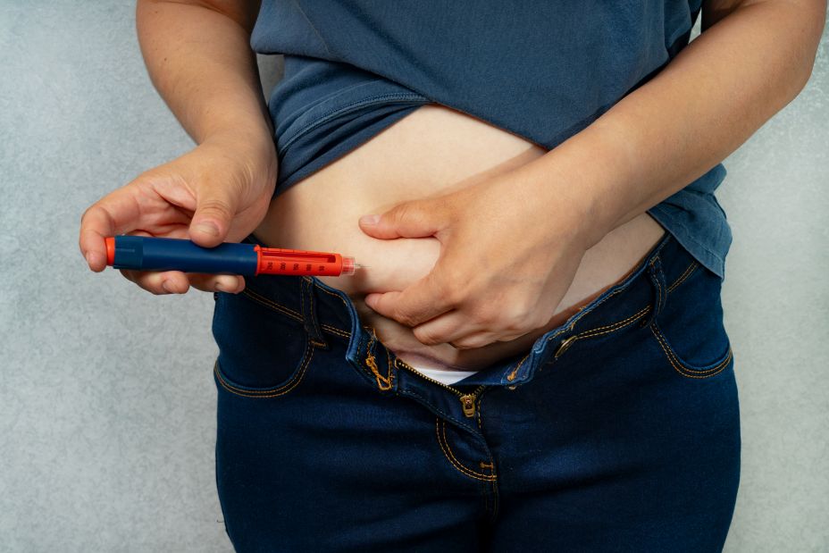 person injecting GLP-1 agonist into midsection
