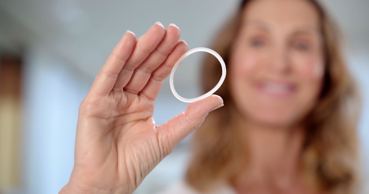 Woman holding estrogen therapy ring